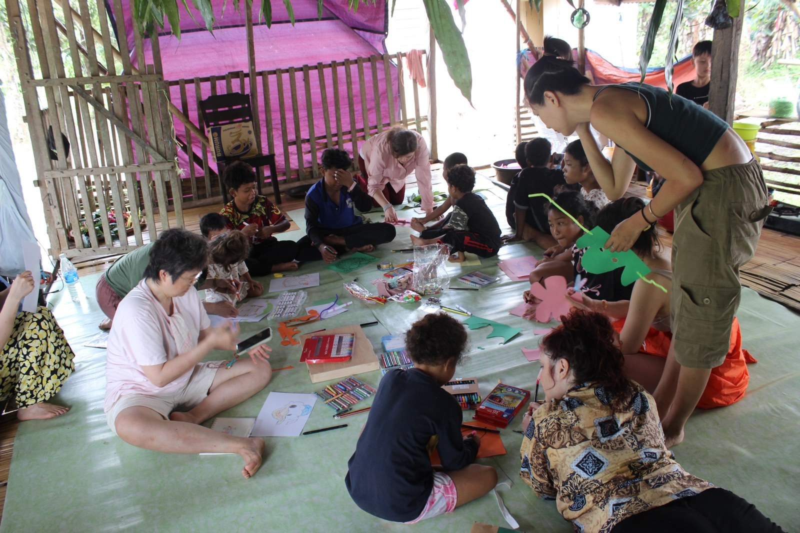 NDP students and Temiar children making masks and drawings together