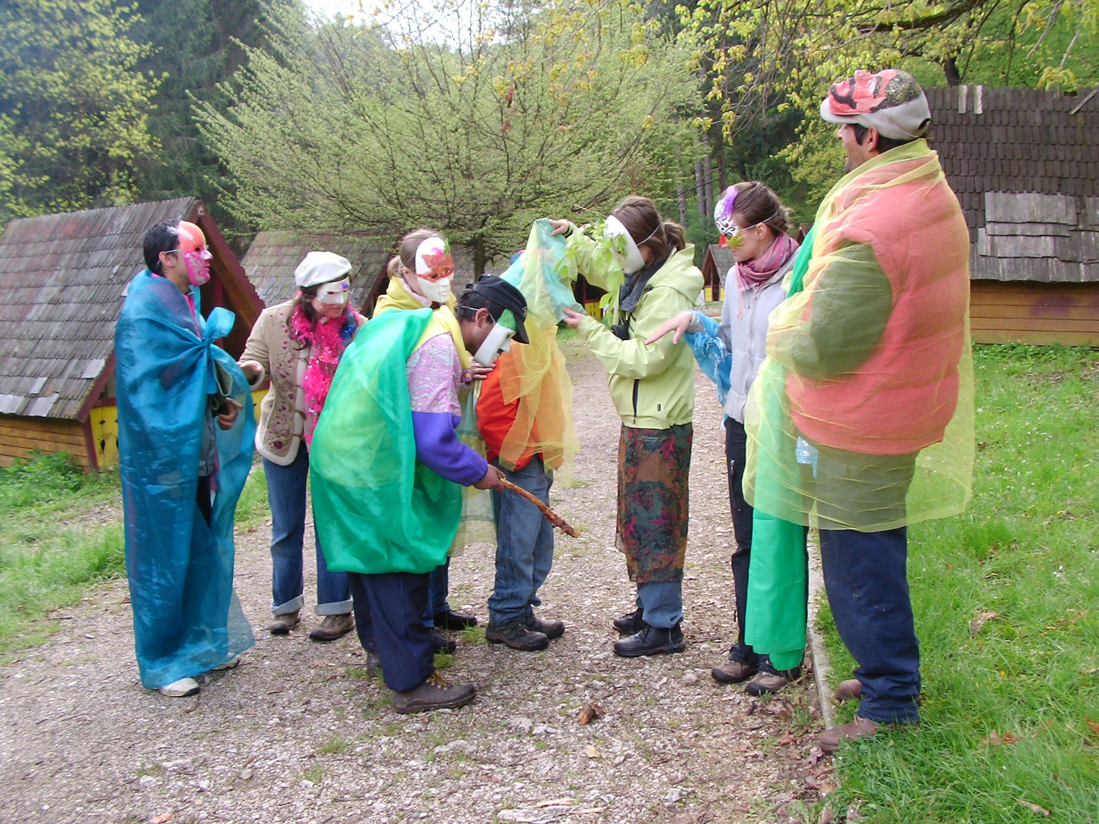 A masked and costumed group taking part in The Railway Boys project outdoors in Romania