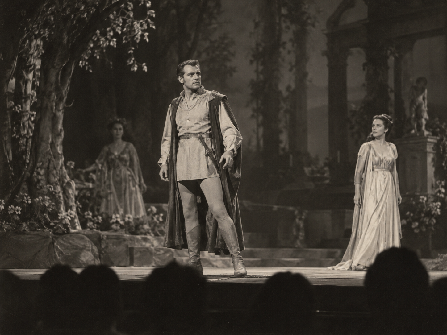 A theatrical scene viewed from the stalls, showing Harry Andrews as Demetrius in A Midsummer Night’s Dream.