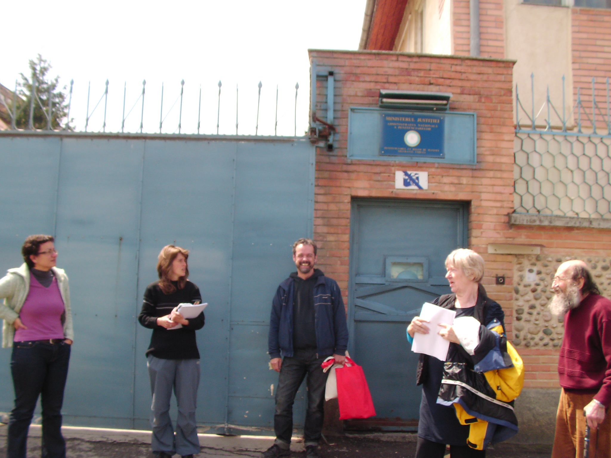 Sue with colleagues outside a prison building during a project