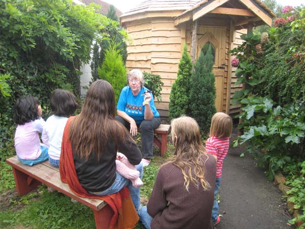 Sue telling stories outside her story cabin
