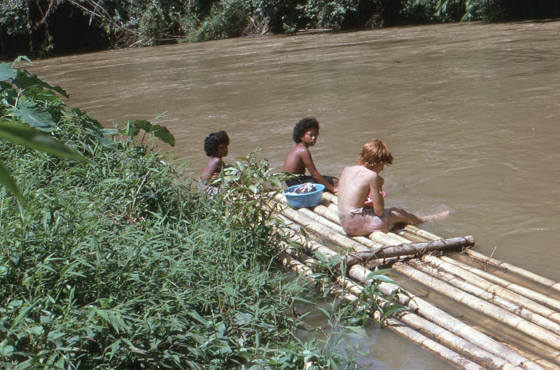 Andy’s sister and Temiar girls washing clothes by a river in Kelantan in the 1970s