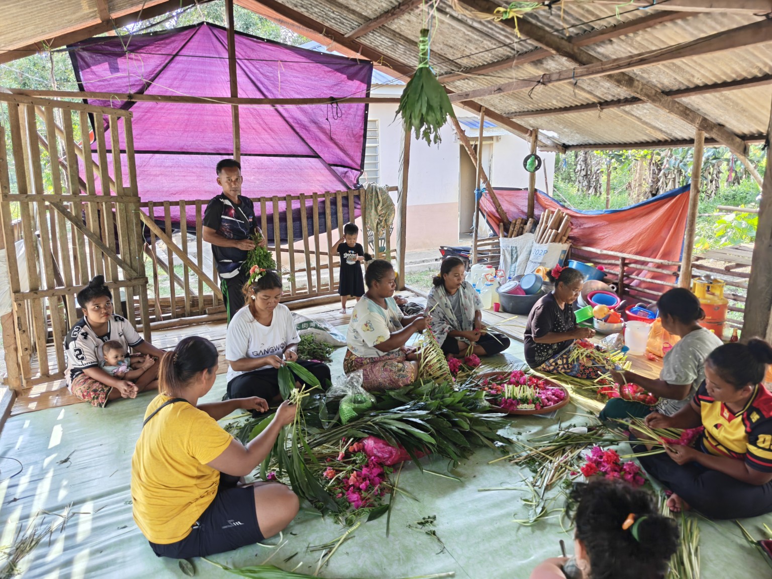 Temiar women preparing leaves and flowers for a gabag in Kelantan in 2026