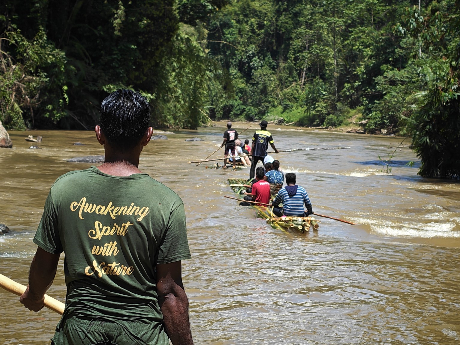 People travelling downriver on bamboo rafts in Kelantan in 2026