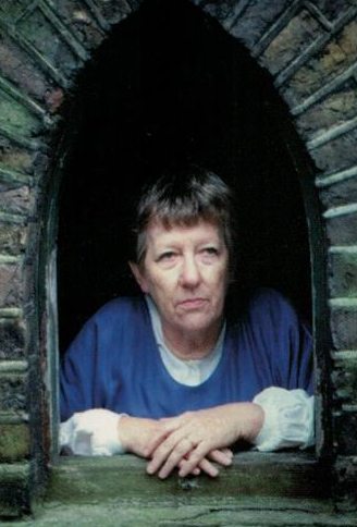 Sue appearing at a small window in costume for The Nurse's Tale